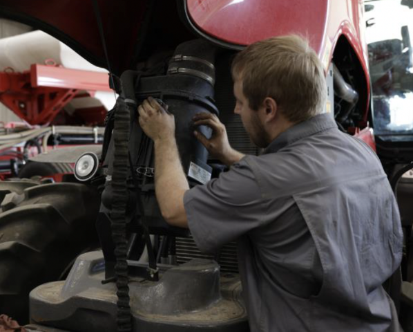 Technician working on tractor